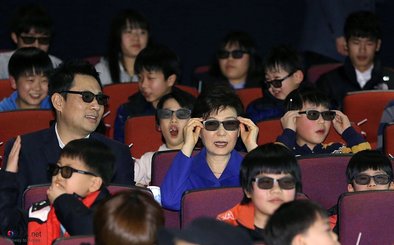 A crowded cinema lobby with moviegoers at a premiere-style screening