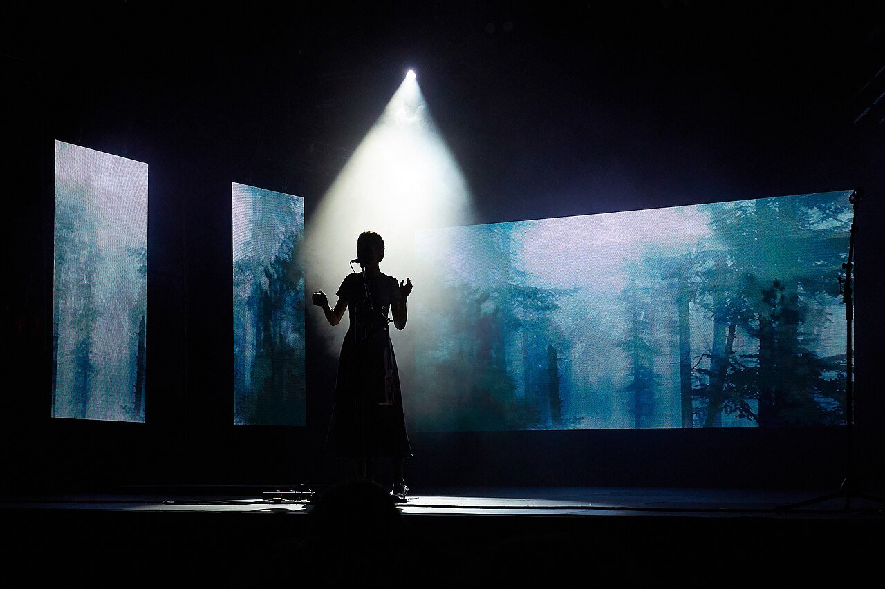 A dark, shadowy figure standing in dramatic light