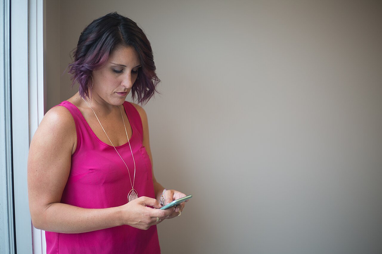 A person messaging on a smartphone