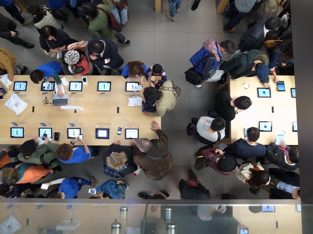 An Apple store front with customers inside