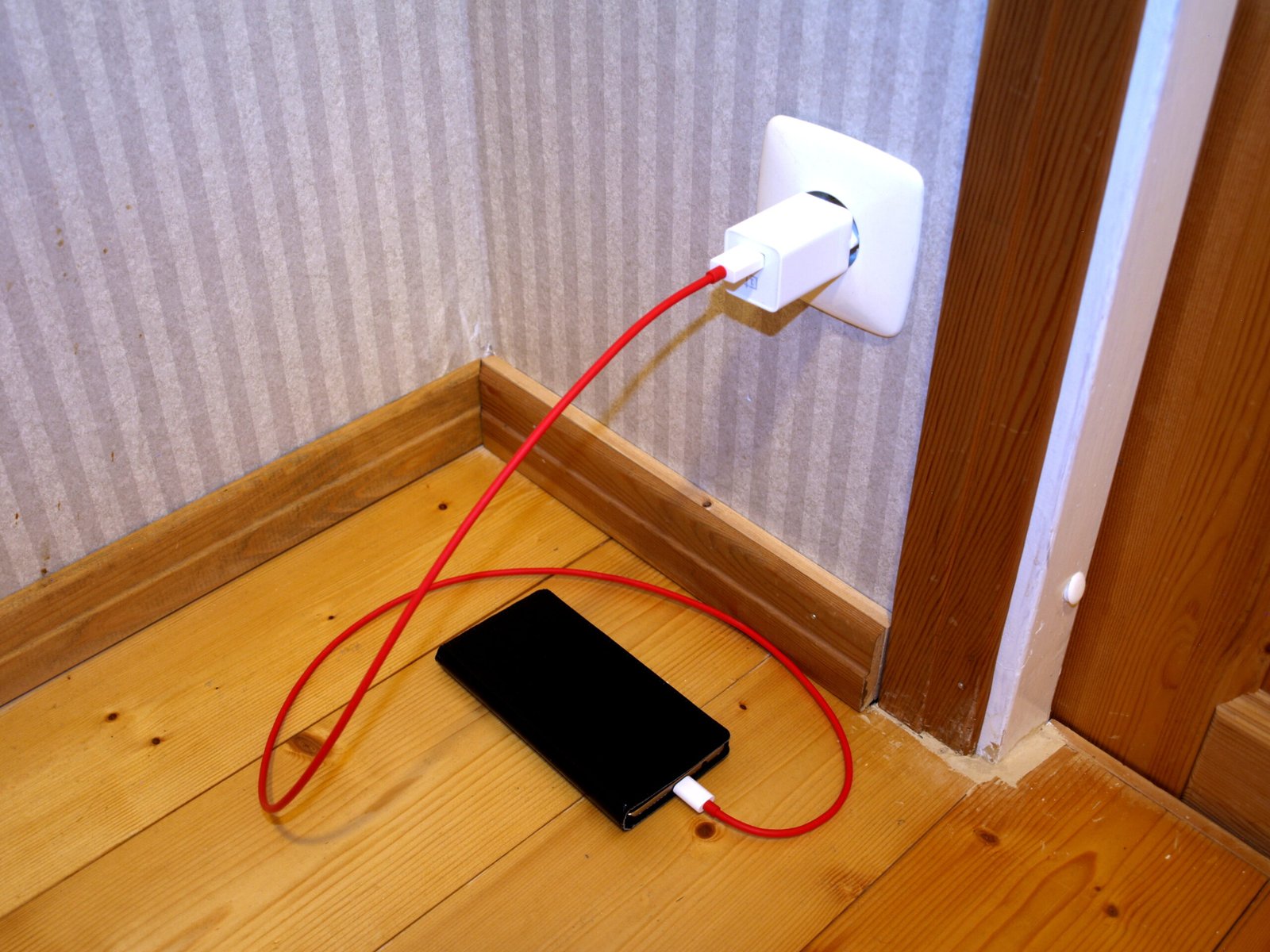 A smartphone plugged in and charging