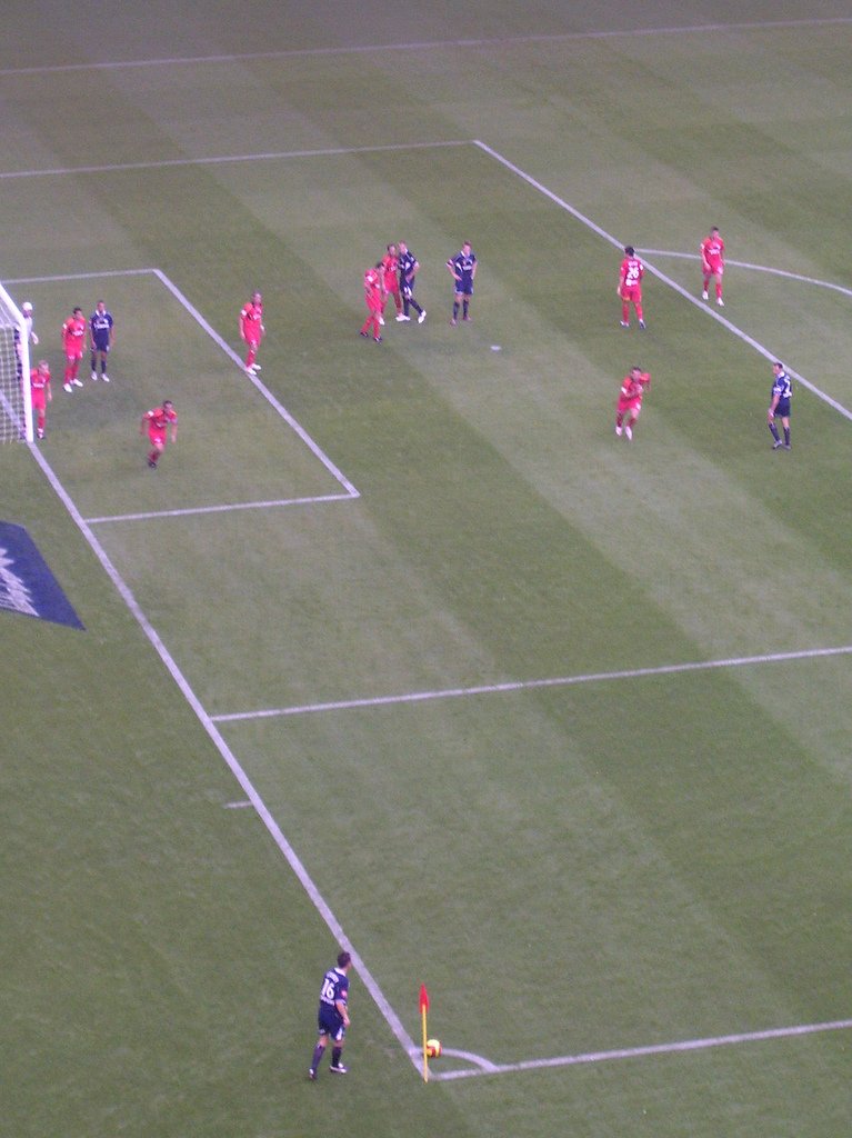 Footballers contesting a corner kick