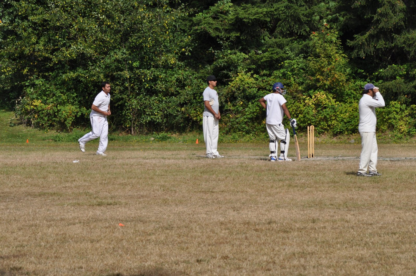 A bowler delivering the ball in a T20 cricket match