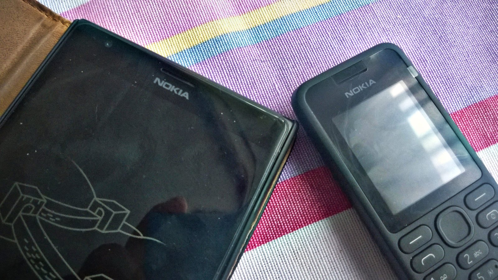 Smartphone next to a feature phone on a table