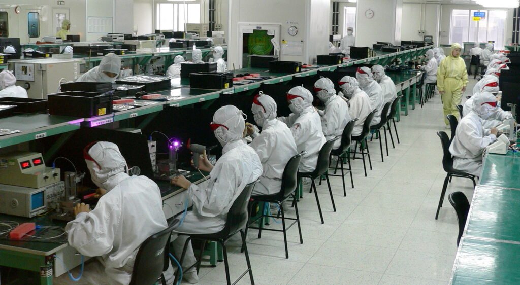 Workers assembling electronics in a factory