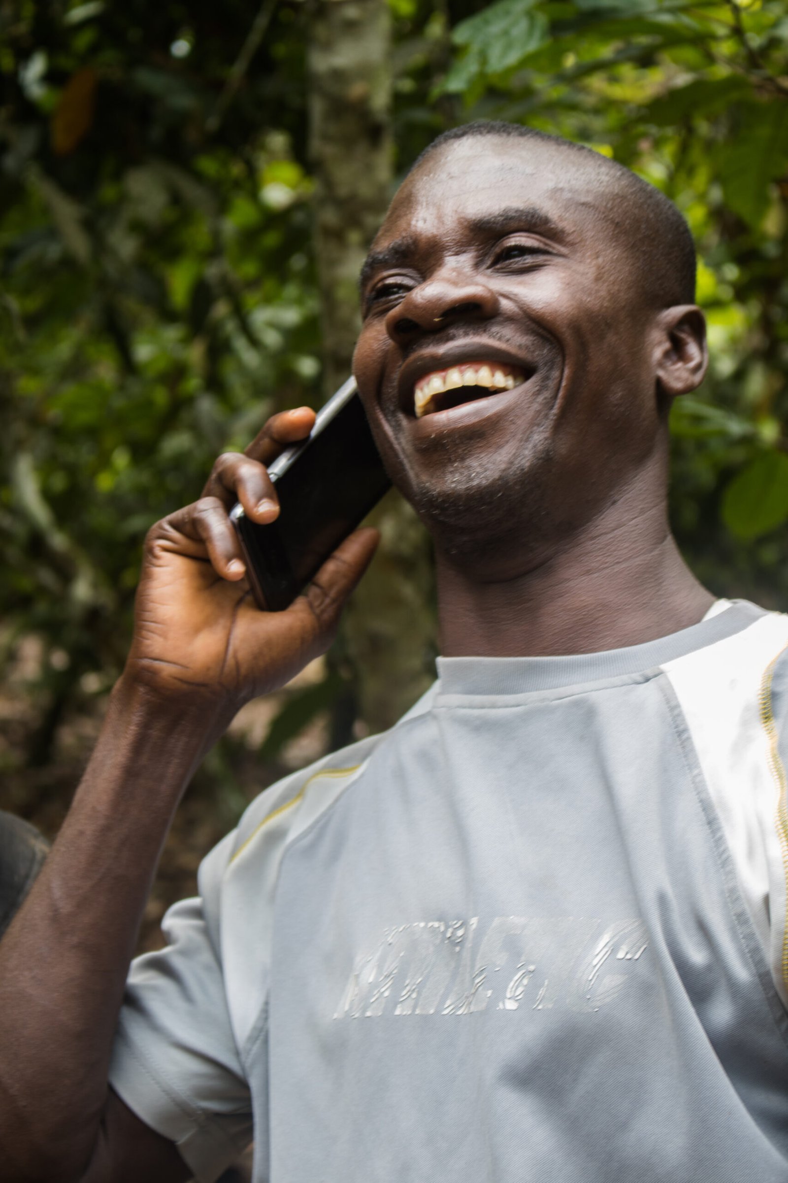 A farmer using a smartphone in a field