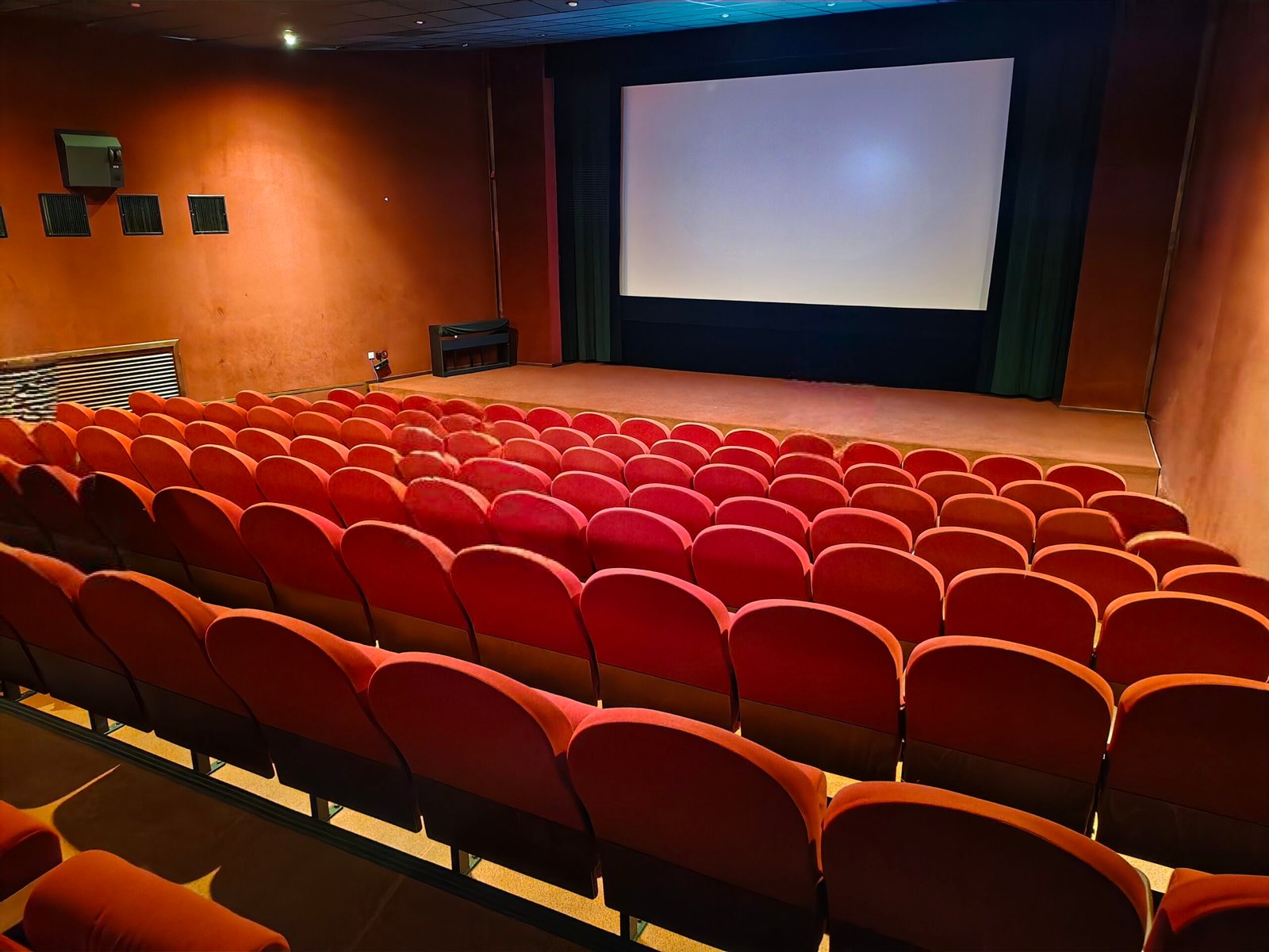 A cinema auditorium with a large screen