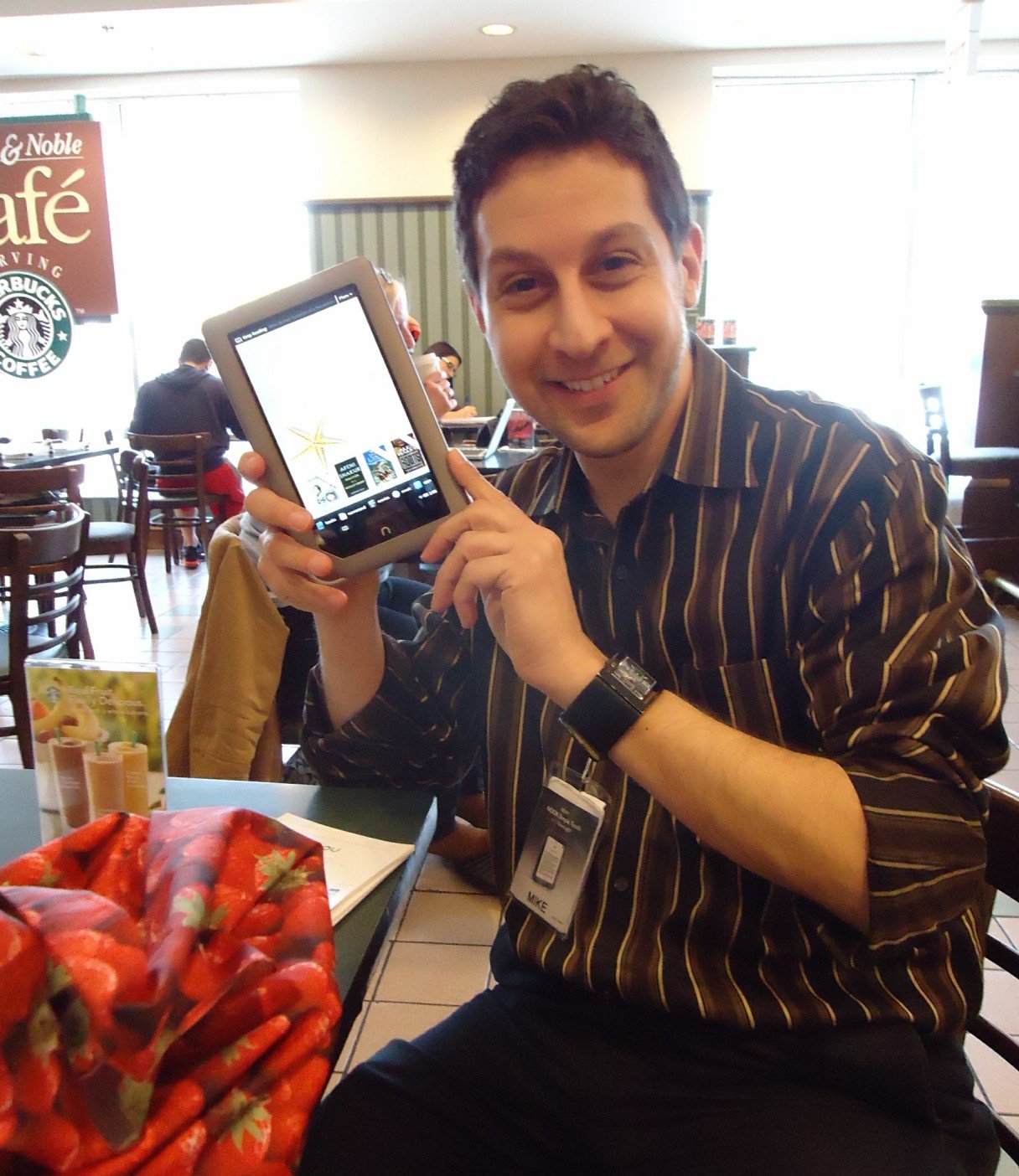 A customer browsing tablets in an electronics market