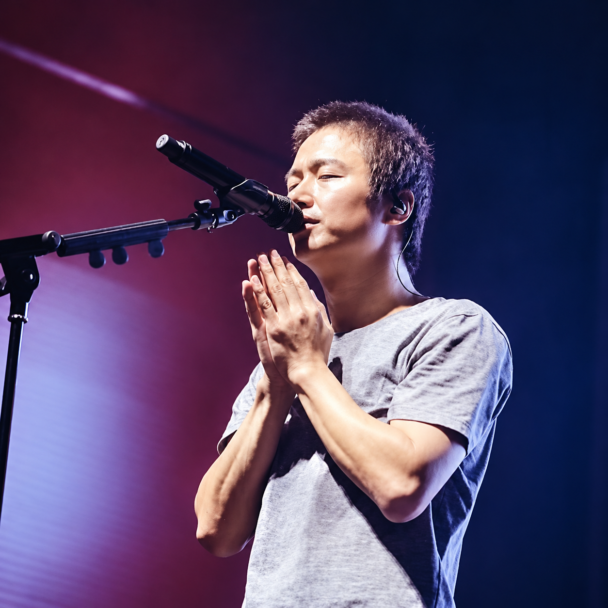 A singer on stage under concert lights