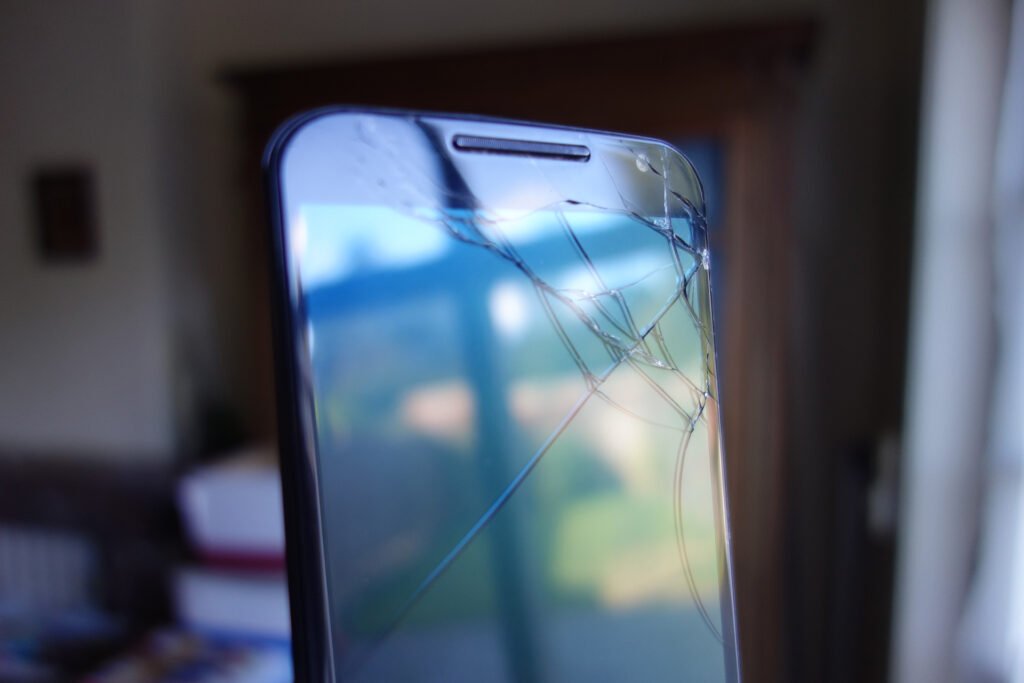 A close-up of a phone screen with a visible fault line