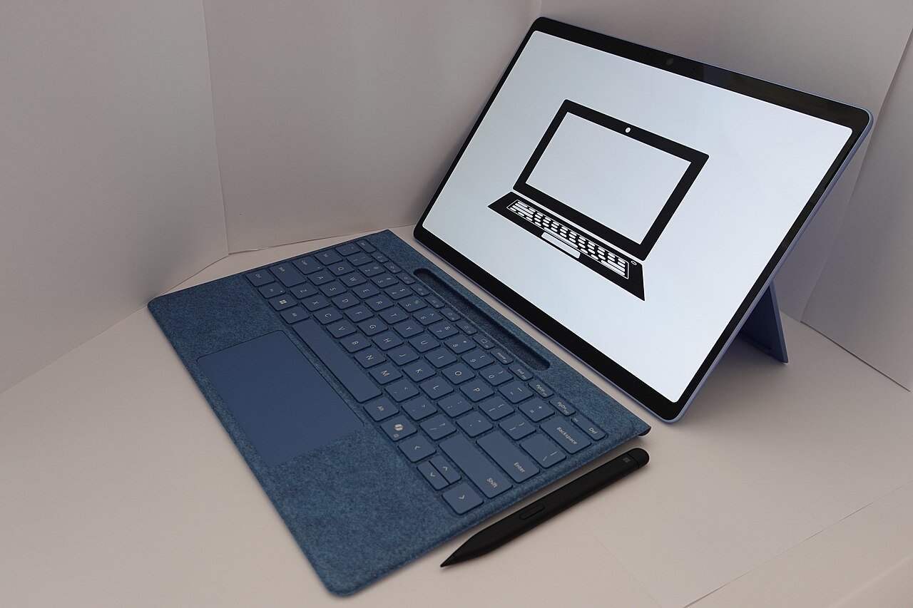 A slim tablet held in one hand showing its thin profile