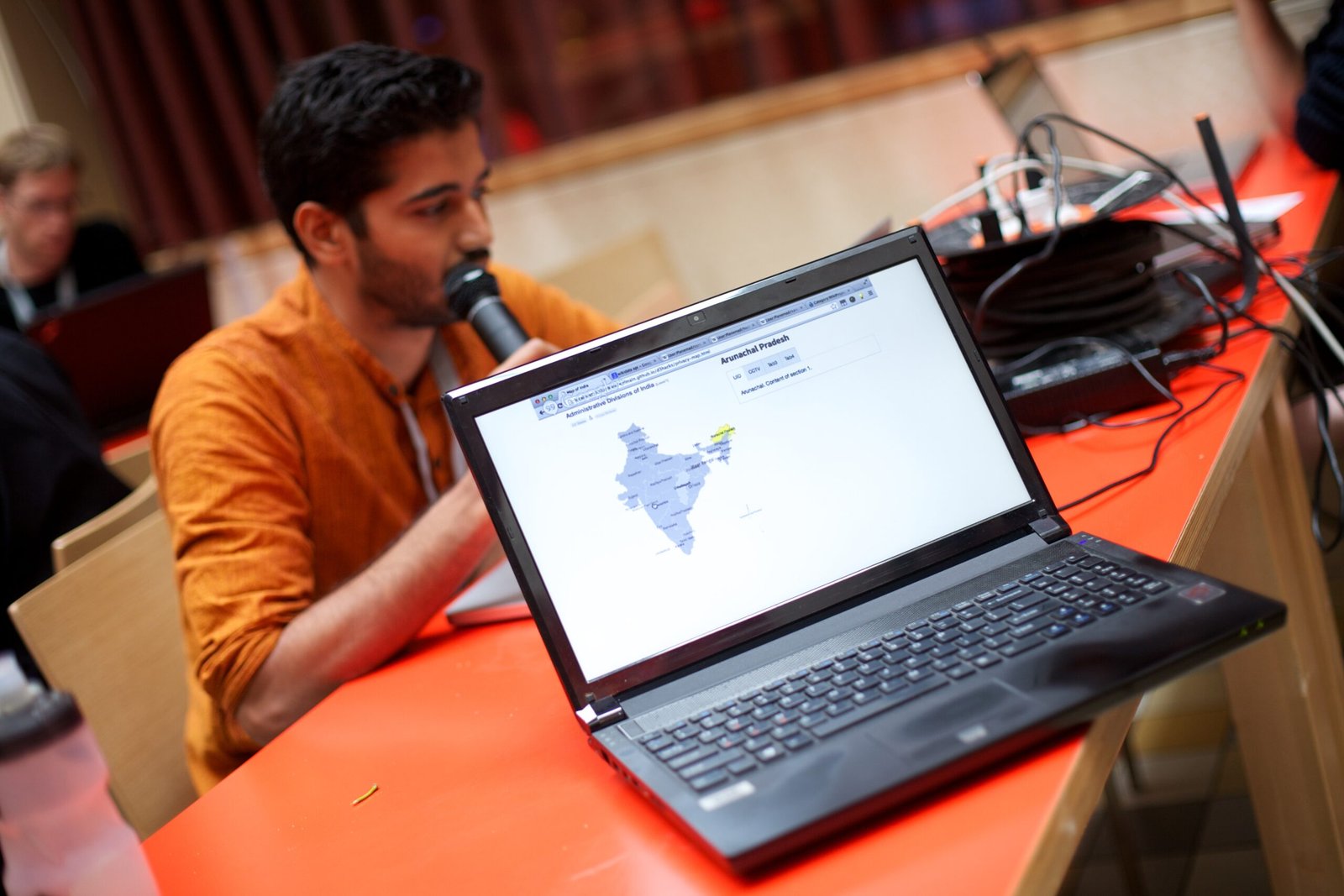 Young developers working on laptops at a hackathon