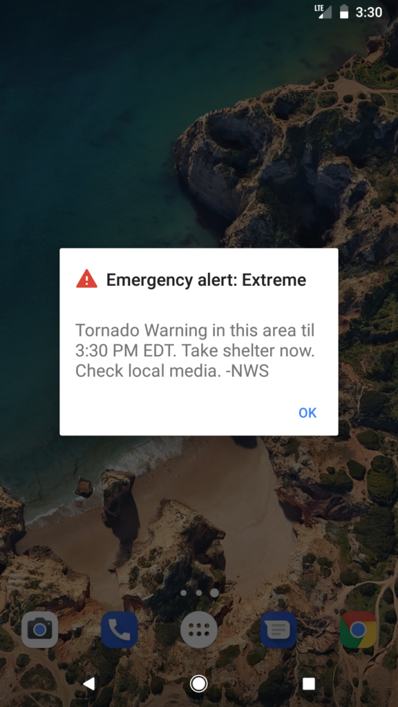 Warning sign about online scams on a phone screen