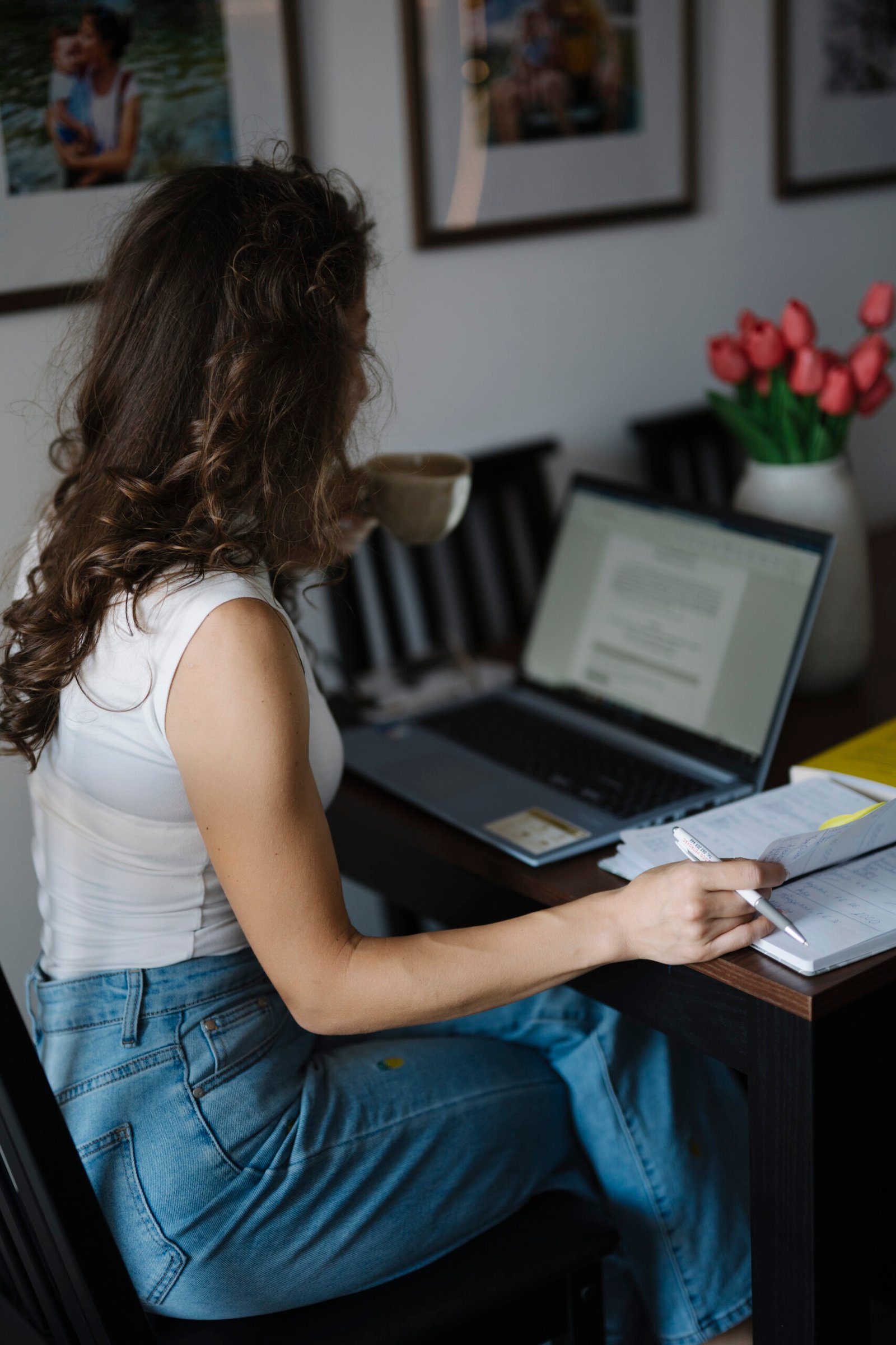 A person working on a laptop at a desk