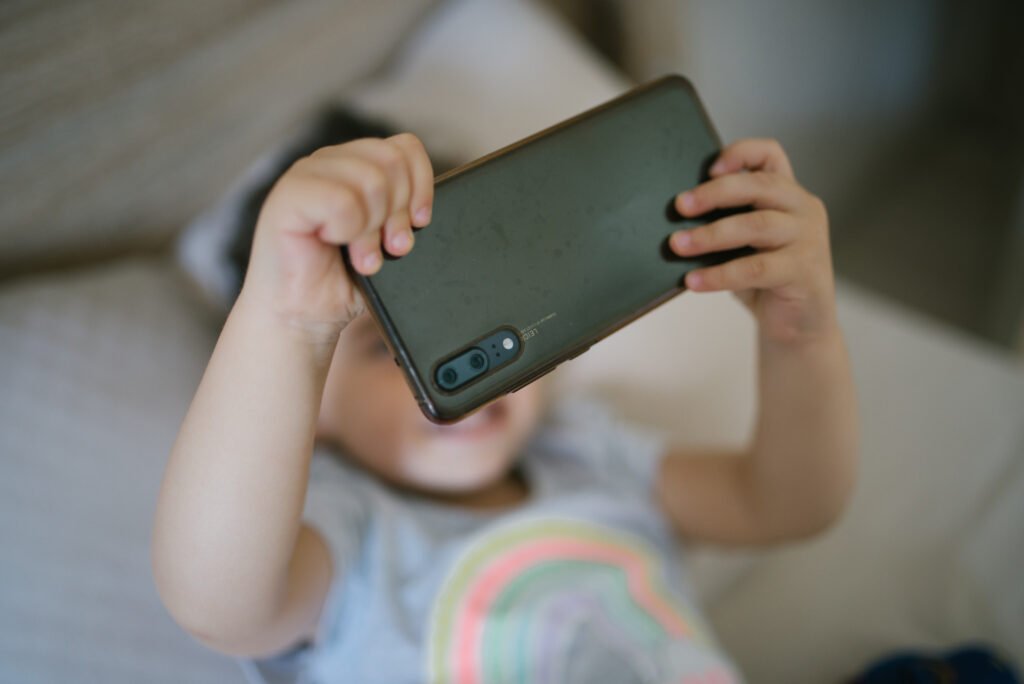 A young girl using a smartphone — Pakistan social media regulator SMPRA