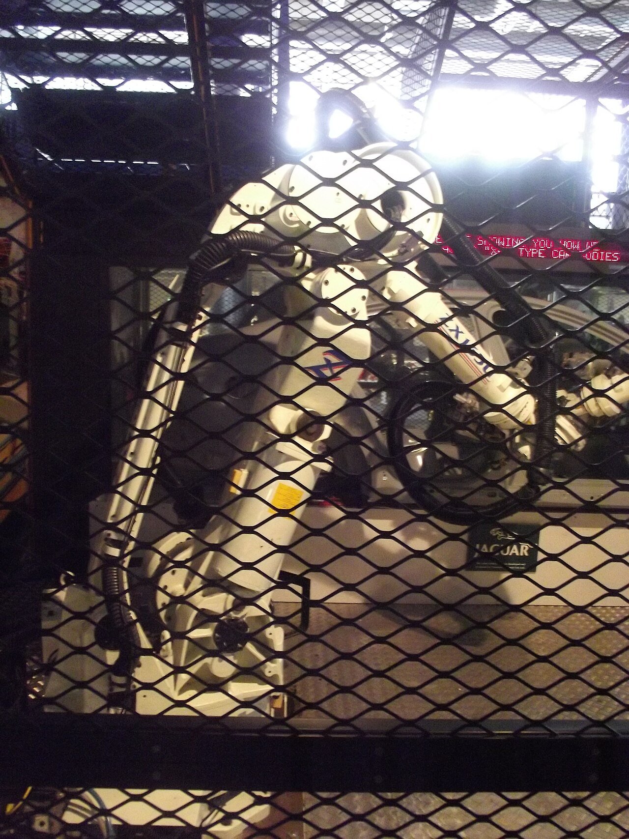 Robotic arm assembling a car body on an assembly line