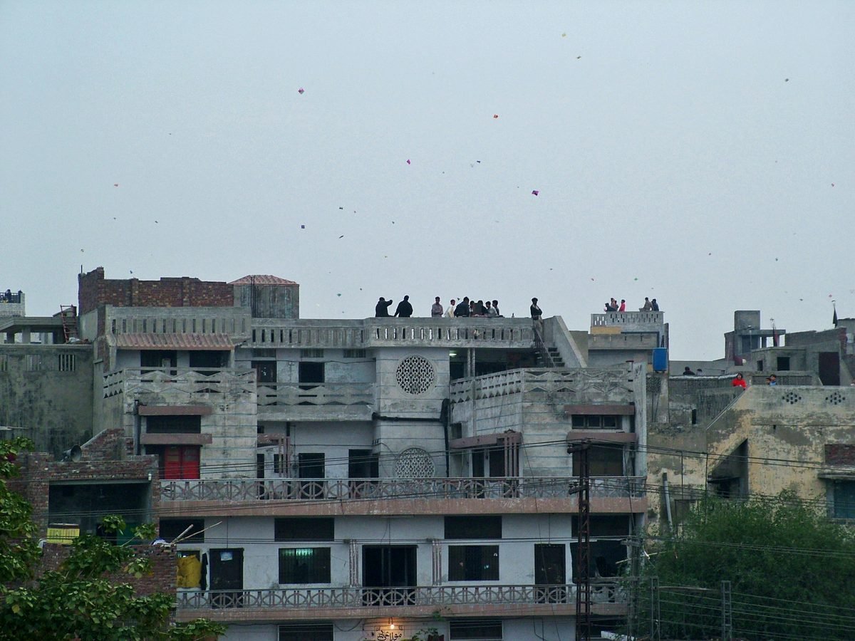 Families flying kites from rooftops of Lahore houses during Basant