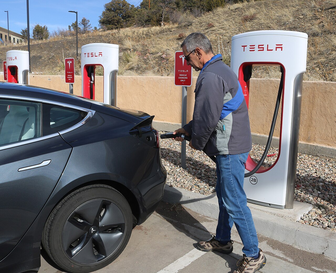 Electric vehicle charging at a charging station