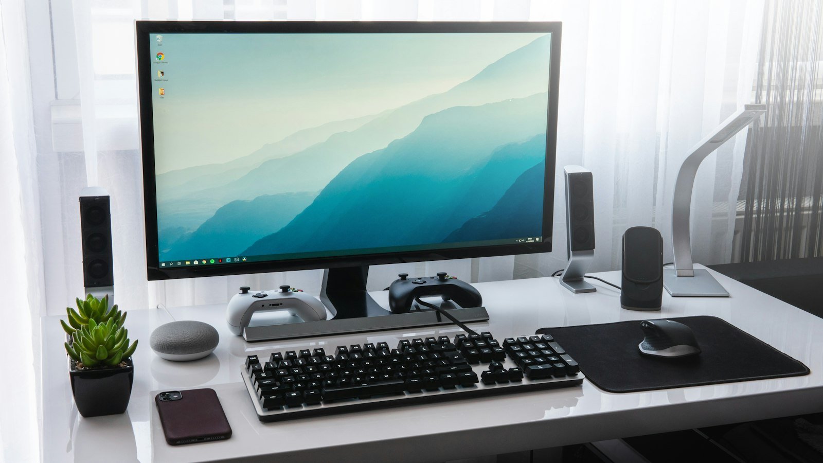 A colourful all-in-one desktop computer on a tidy desk