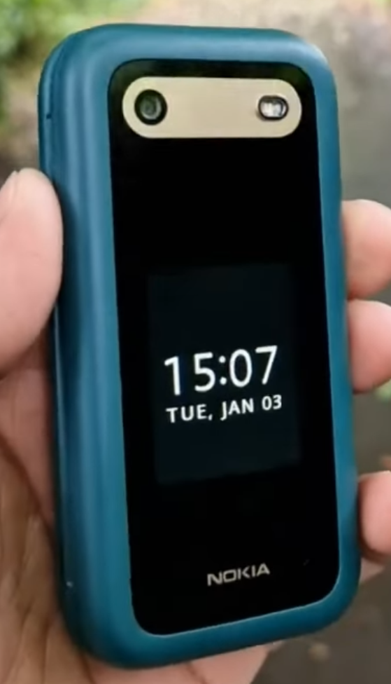 Nokia flip phone next to an earlier Nokia clamshell model