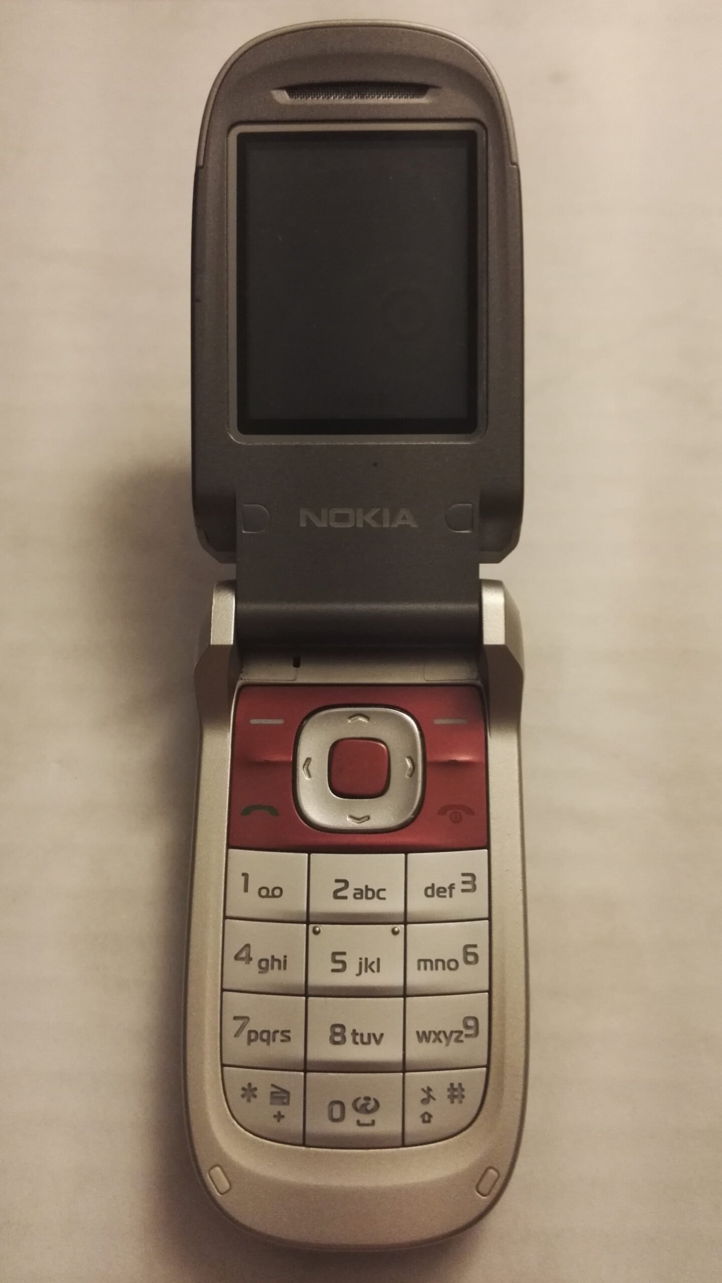 Flip phone opened to reveal the keypad and screen