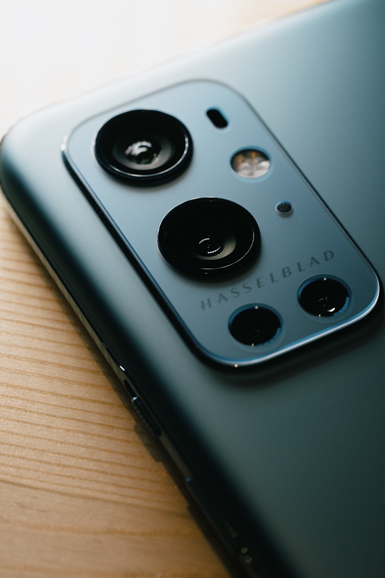 Close-up of a Hasselblad-branded camera module on a OnePlus 9 Pro, a related brand showing Oppo's camera partnership history