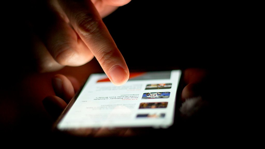 A person scrolling on a smartphone — the PEC Digital E-Card for registered engineers is now accessed digitally instead of on a printed card. Photo: Japanexperterna.se, CC BY-SA 2.0 via Wikimedia Commons