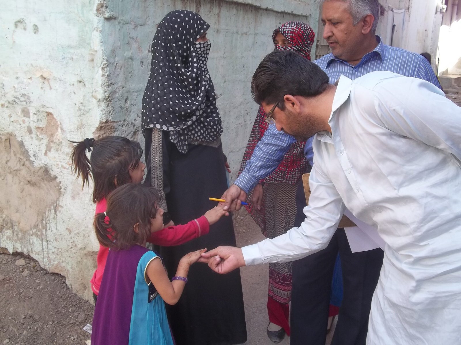 Pakistan polio cases 2026: a health worker checks children for polio vaccination marks in Pakistan (file photo)