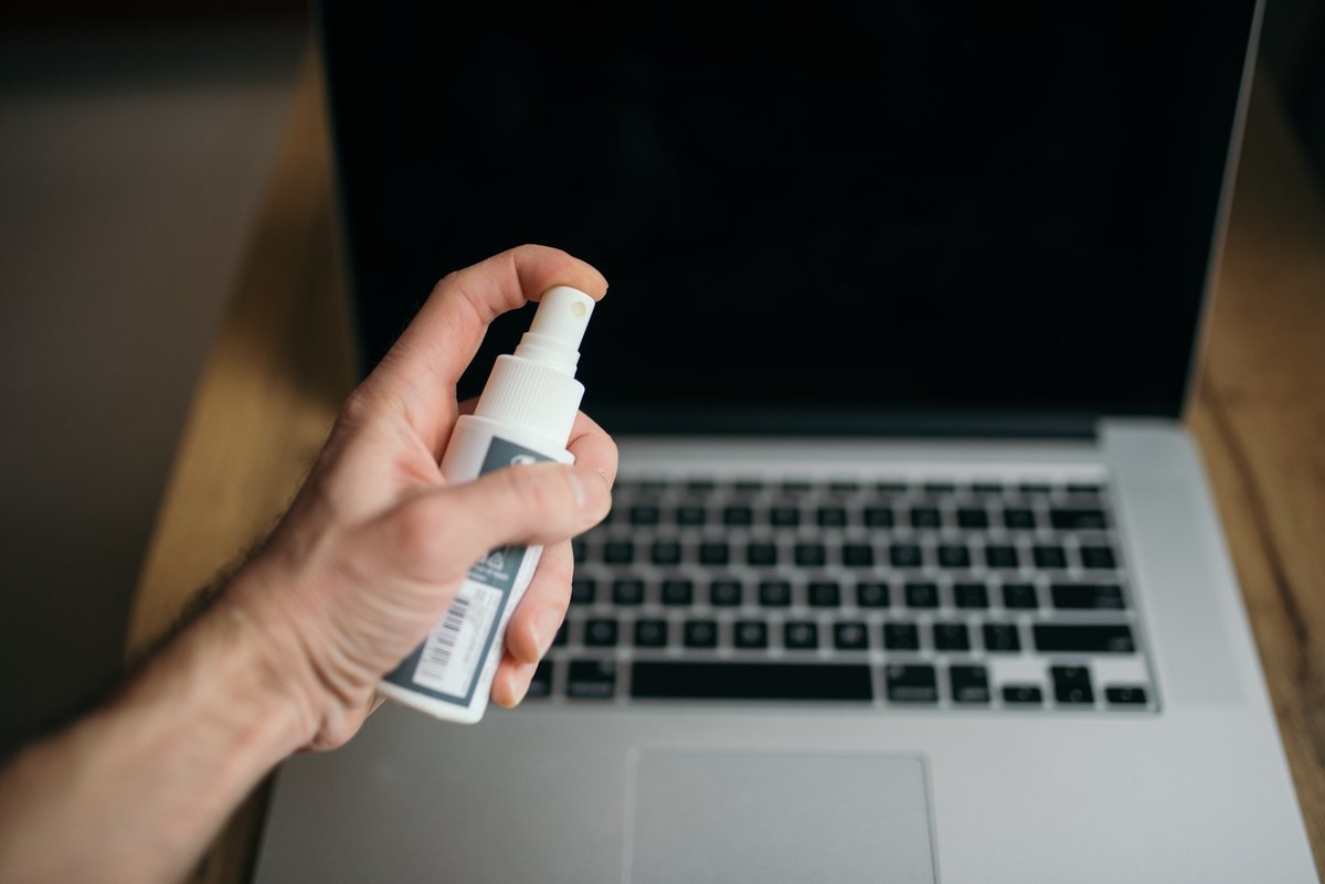 Cleaning a laptop screen as users are advised to remove old Popcorn Time installs to eliminate botnet risk