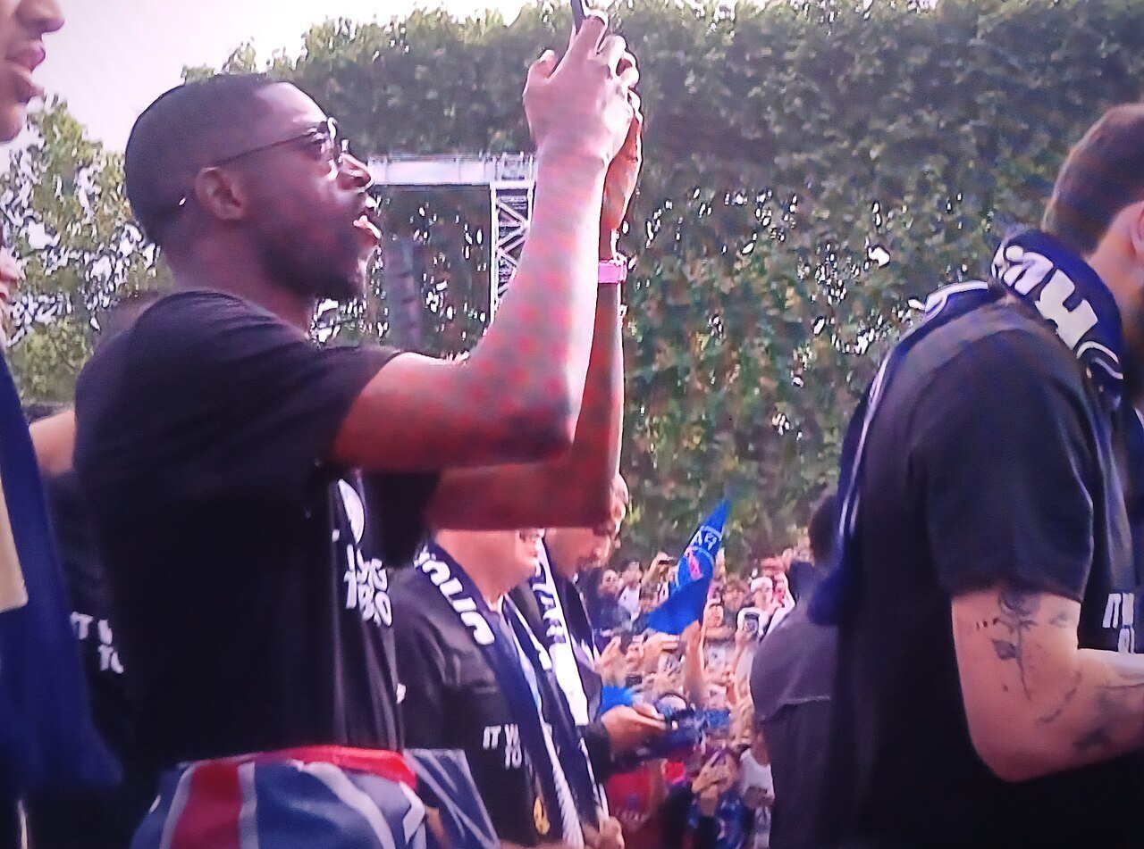 PSG players and staff celebrate with supporters in Paris