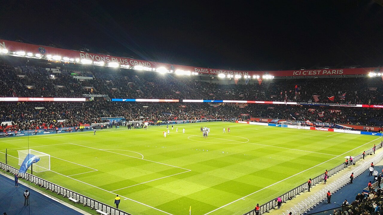 The Parc des Princes packed with fans under the lights during a night match