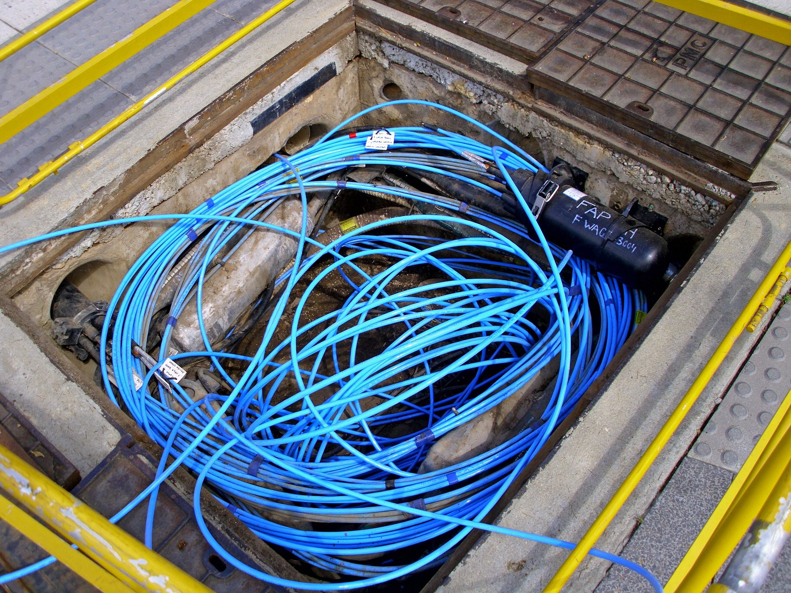 Coiled blue fibre-optic cables inside a telecom pit — the PTA wants the fiber-to-the-tower ratio raised to 20%