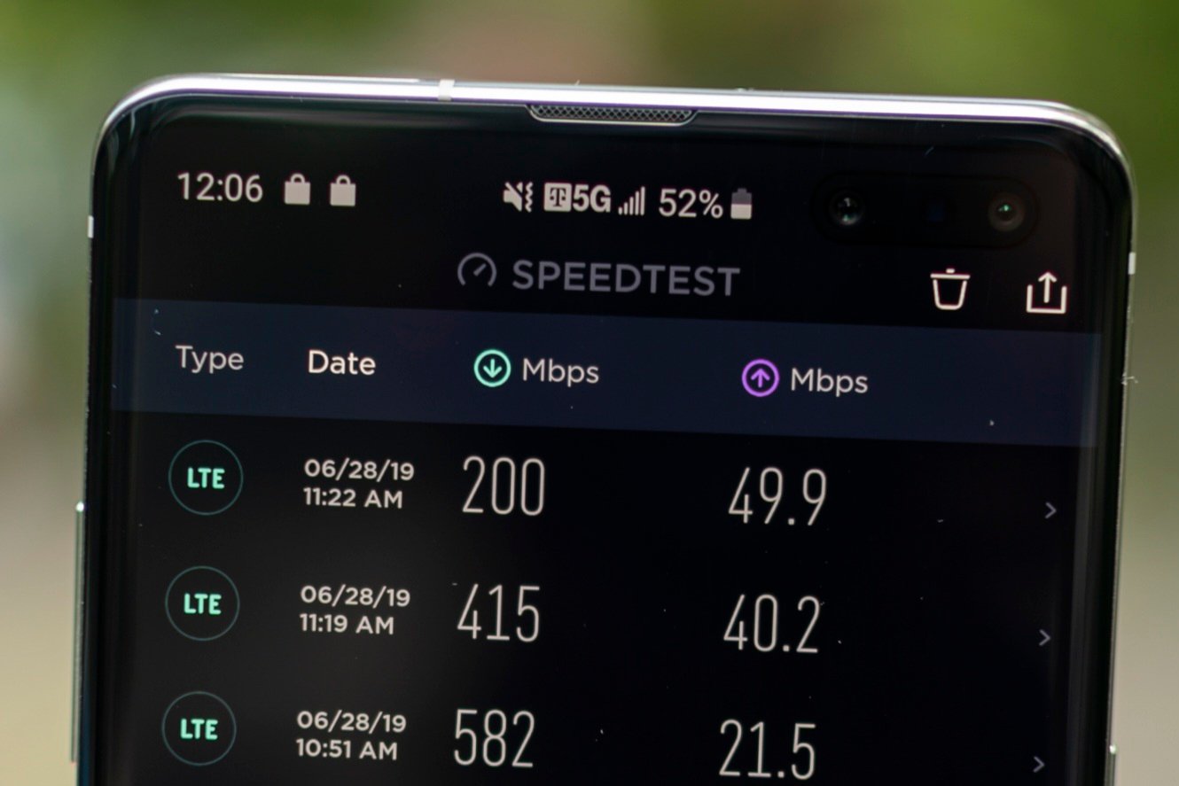 A Samsung Galaxy S10 5G smartphone running a speed test with the 5G indicator in the status bar — the PTA’s phased target is 100 Mbps median on 5G